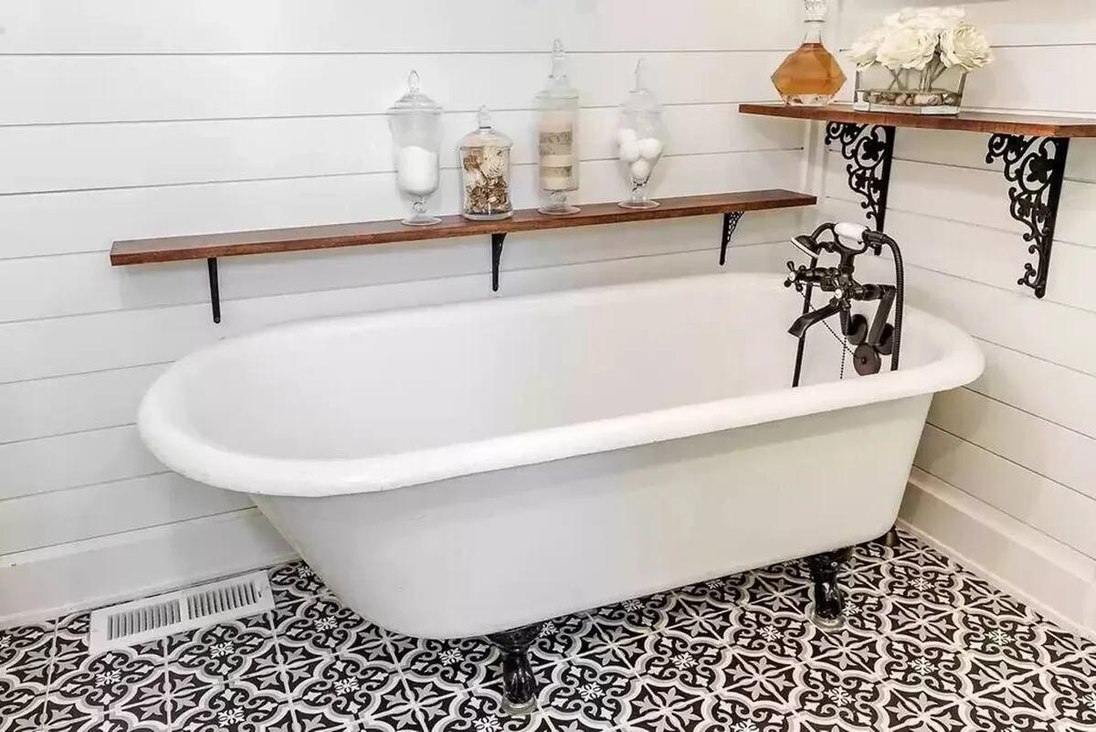 A spa-like bathroom featuring a freestanding bathtub, wooden shelf, and decorative jars. The setting is calm and serene, ideal for unwinding after adventurous days, with thoughtful touches creating a rejuvenating atmosphere.